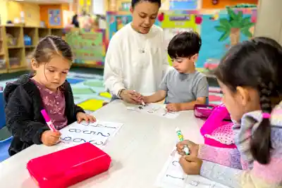 Preschool children creating art crafts, singing together, and exploring musical instruments in creative play at Sierra Preschool